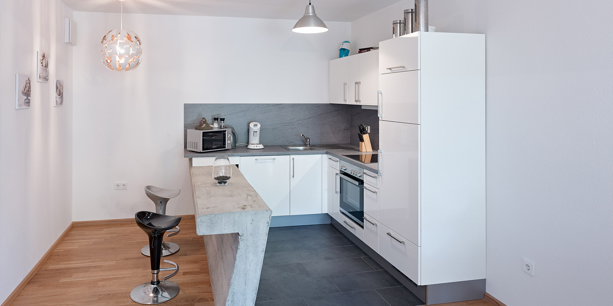 Moderne Küche mit heller Wandfläche als Beispiel für spezielle Beschichtungen