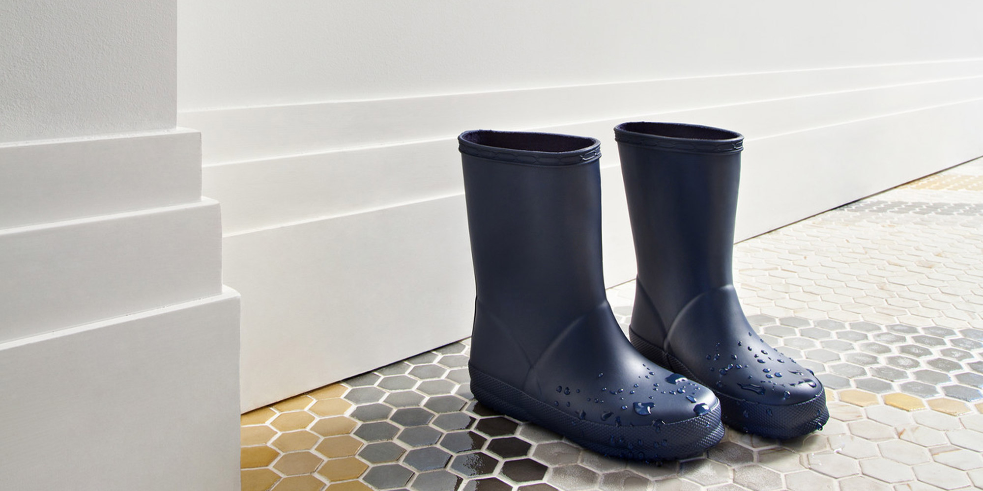 Ein moderner Flur mit einer extra hohen weißen Fußleiste in kantiger Stufenoptik.